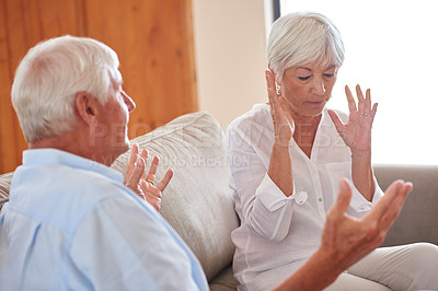 Buy stock photo Shot of a senior couple having an argument at home