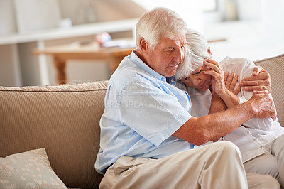 Buy stock photo Shot of a senior man consoling his wife