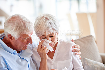 Buy stock photo Shot of a senior man consoling his wife