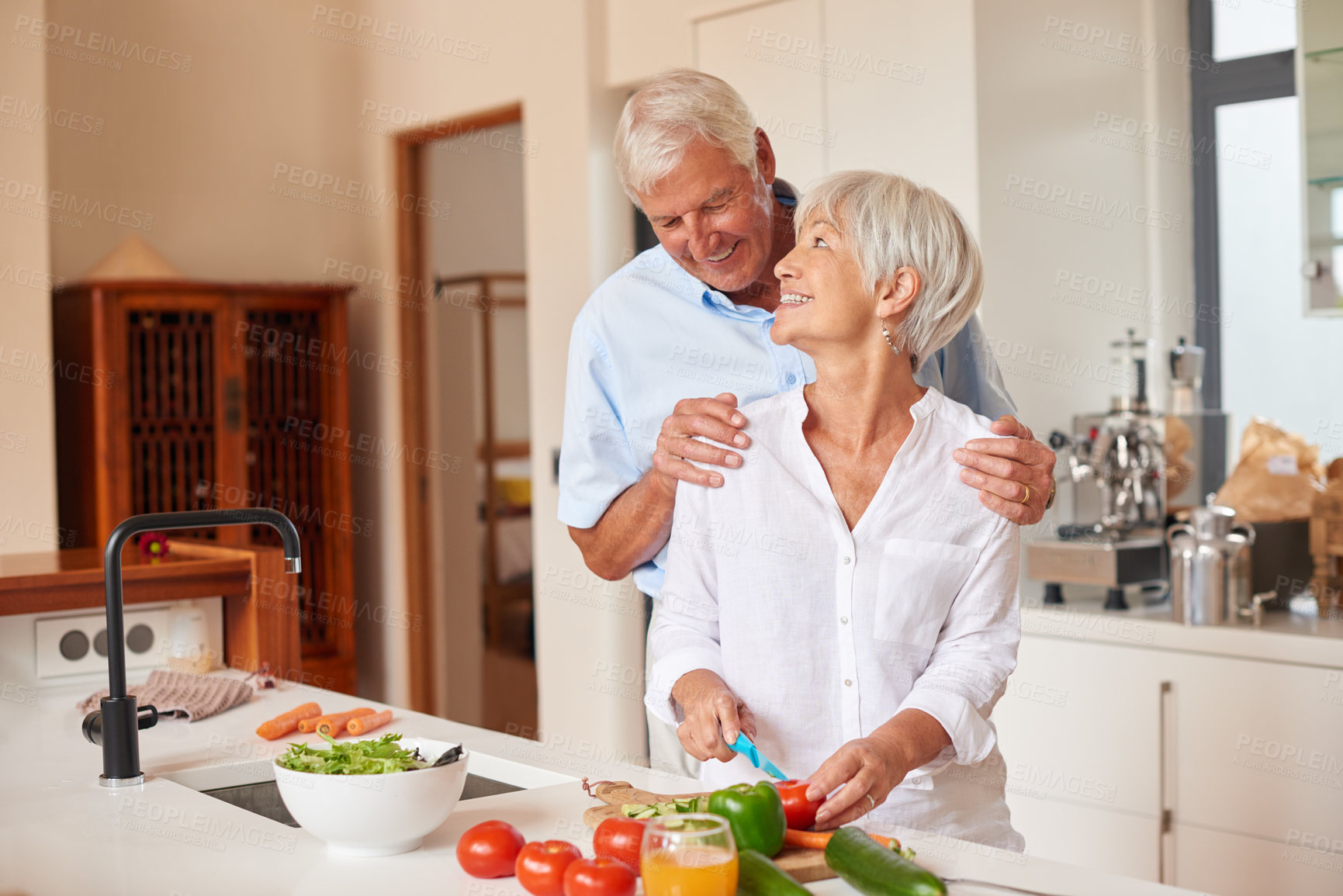 Buy stock photo Shot of a senior couple preparing a meal in the kitchen