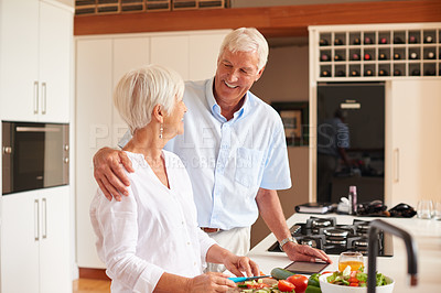 Buy stock photo Shot of a senior couple preparing a meal in the kitchen
