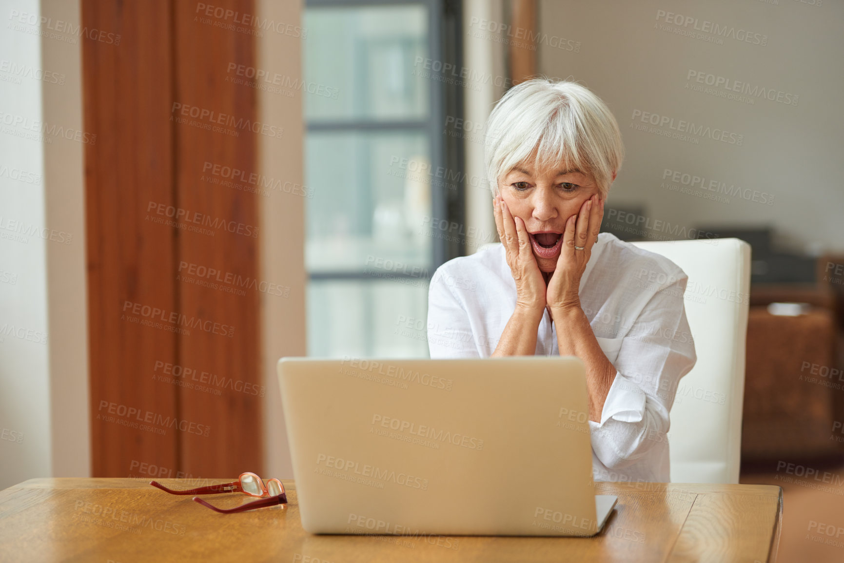 Buy stock photo Shot of a senior woman using a laptop