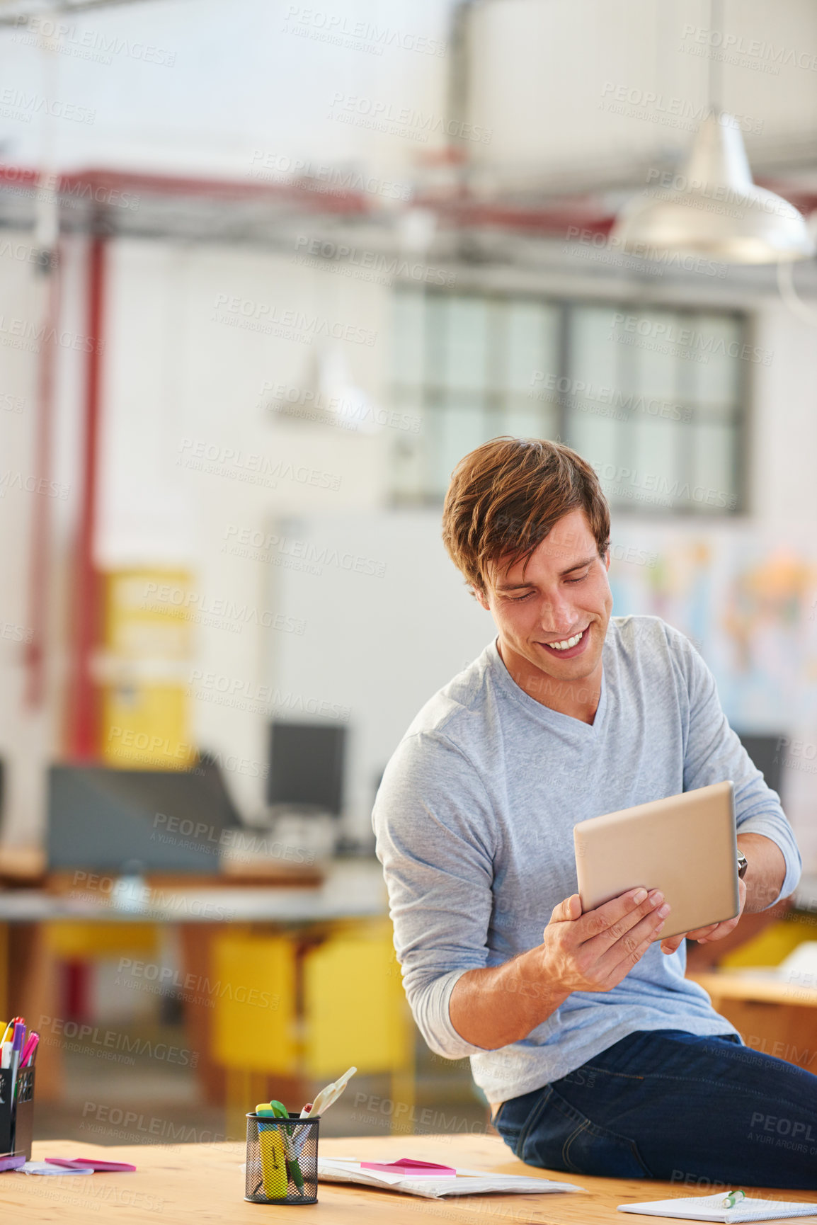 Buy stock photo Shot of a designer using a digital tablet while working in an office