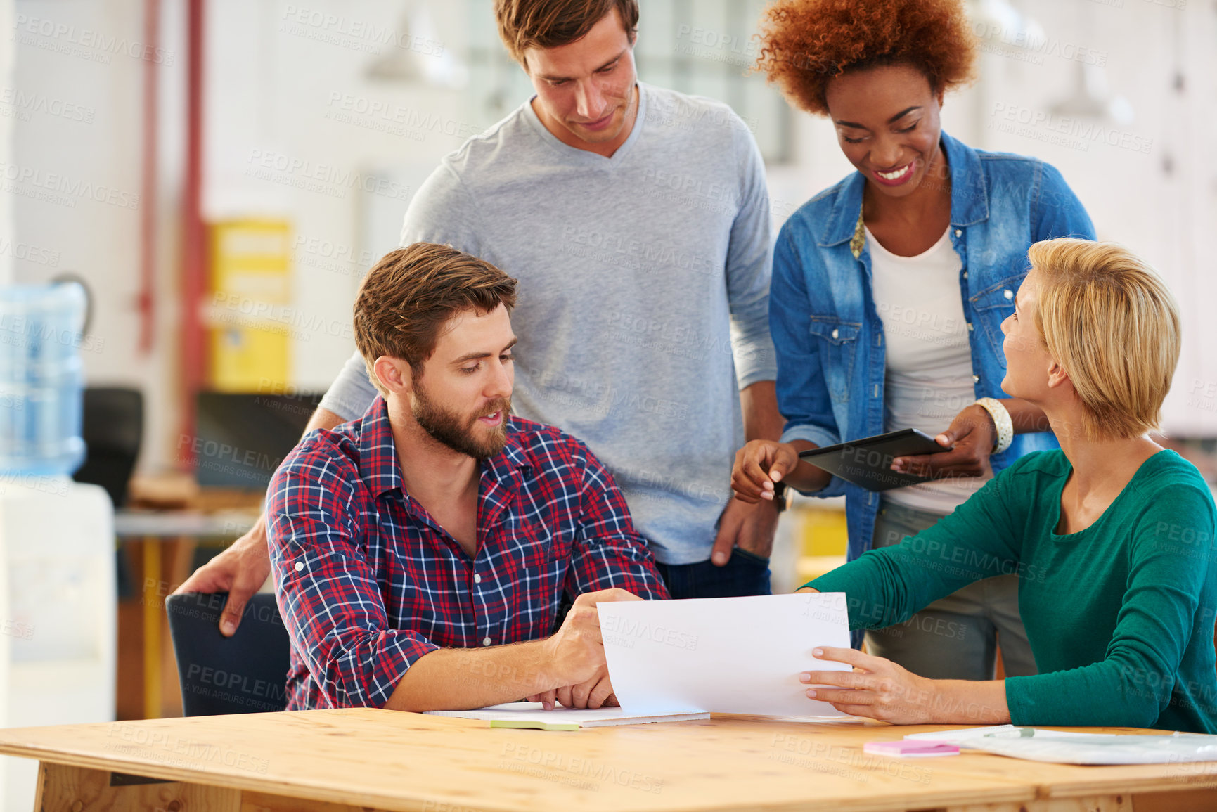 Buy stock photo Shot of a group of colleagues  collaborating with each other on a project in an office