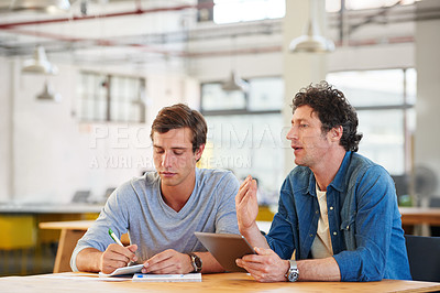 Buy stock photo Shot of colleagues  collaborating with each other on a project in an office