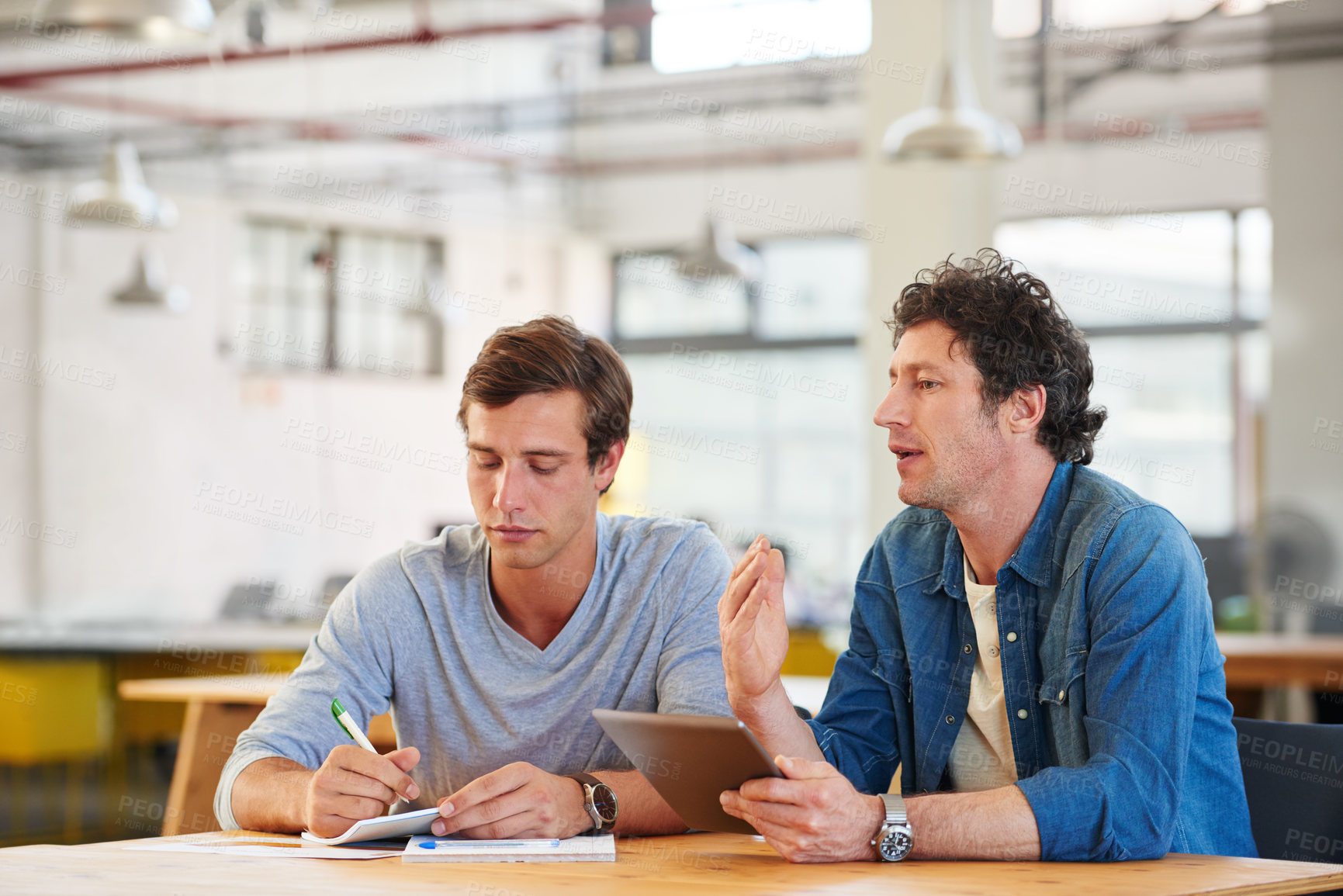 Buy stock photo Shot of colleagues  collaborating with each other on a project in an office