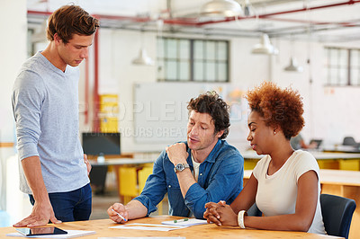 Buy stock photo Shot of a group of colleagues  collaborating with each other on a project in an office