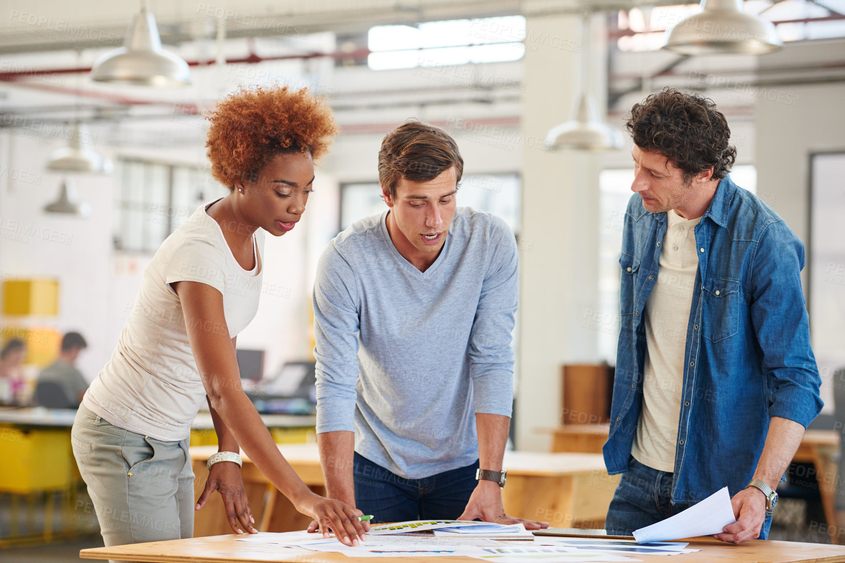 Buy stock photo Shot of a group of colleagues collaborating with each other on a project in an office