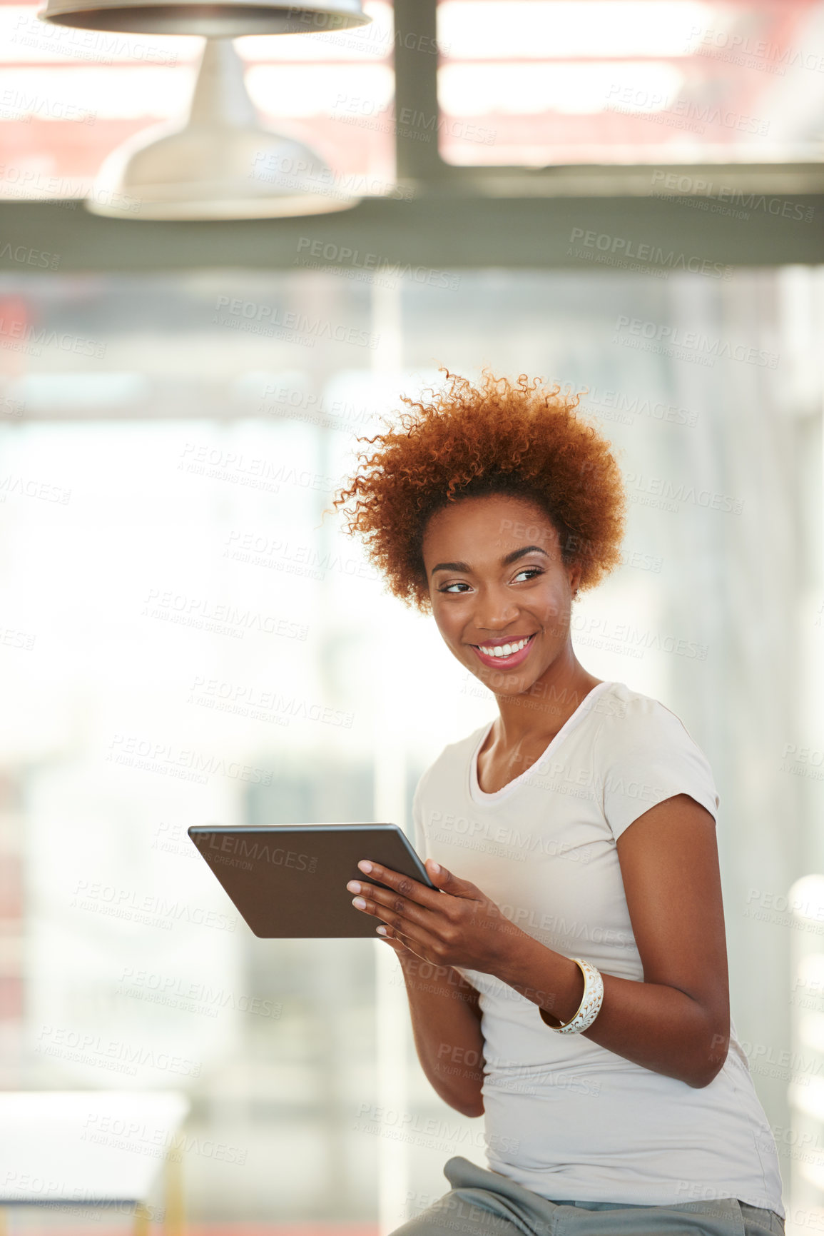 Buy stock photo Shot of a young businesswoman using a digital tablet in the office