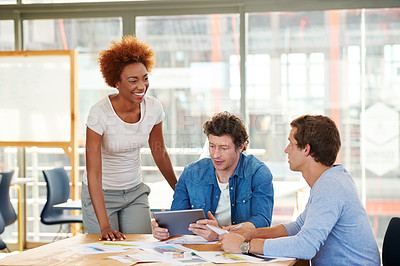 Buy stock photo Shot of a group of colleagues collaborating with each other on a project in an office