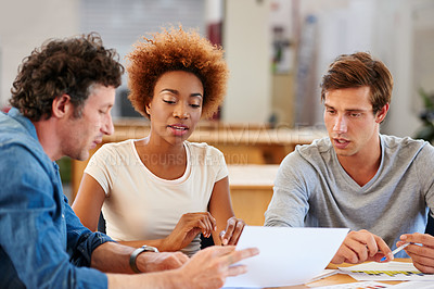 Buy stock photo Shot of a group of colleagues collaborating with each other on a project in an office