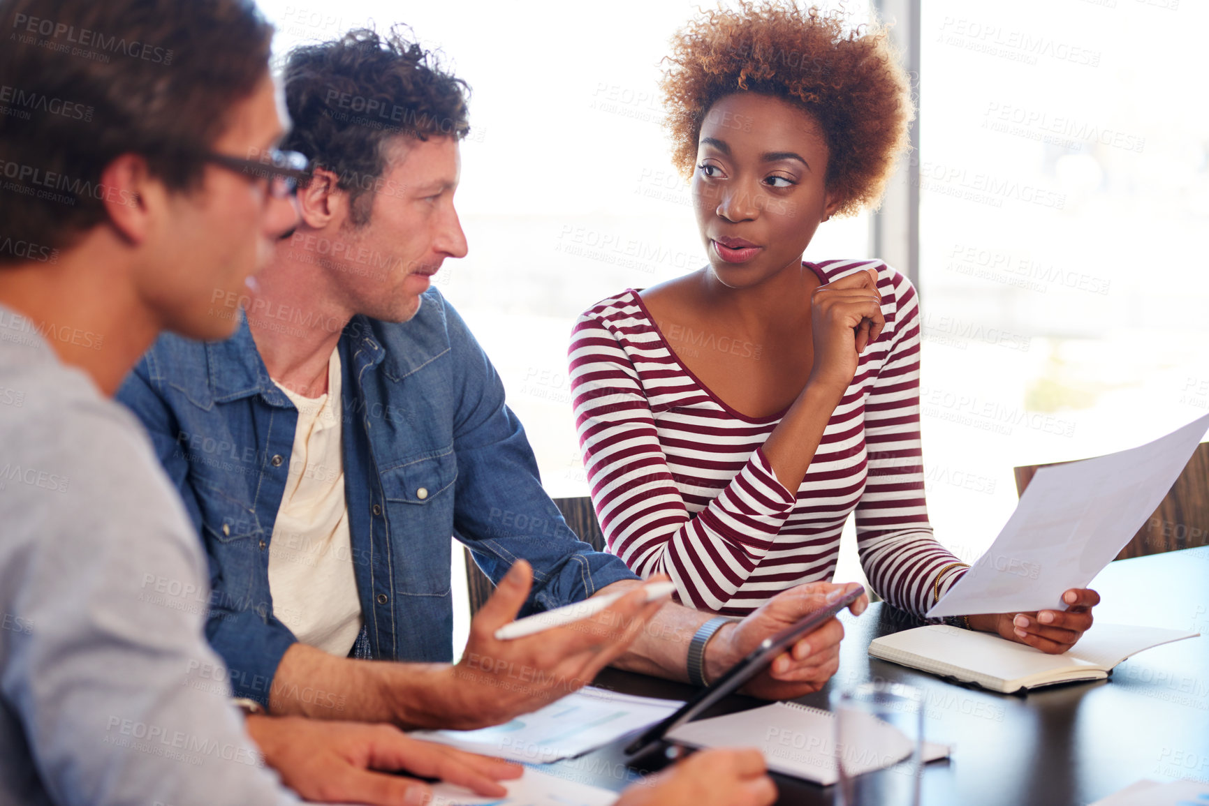 Buy stock photo Shot of a group of colleagues collaborating with each other on a project in an office