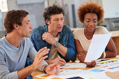 Buy stock photo Shot of a group of colleagues collaborating with each other on a project in an office