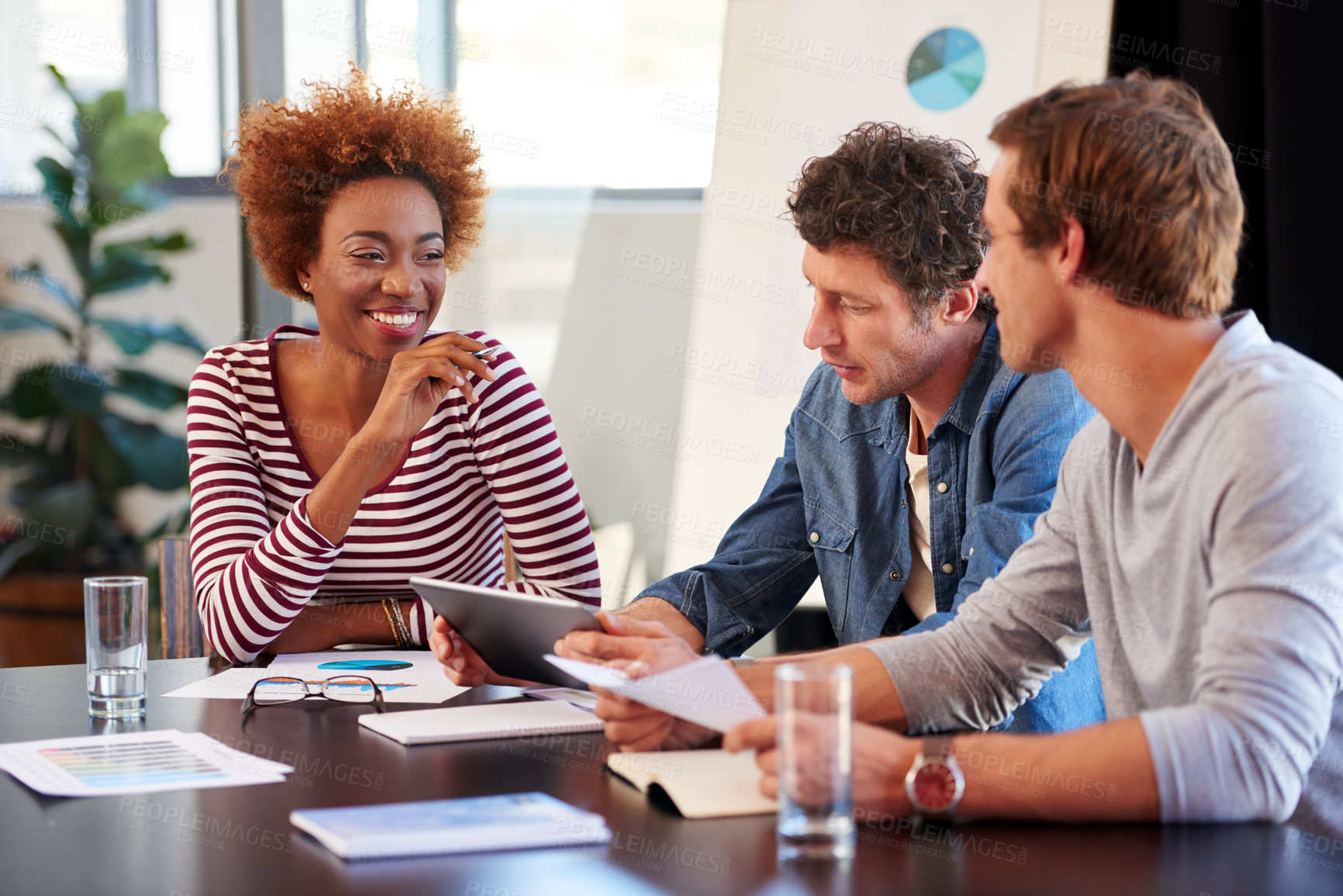 Buy stock photo Shot of a group of colleagues collaborating with each other on a project in an office