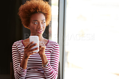 Buy stock photo A young businesswoman using her phone in the office