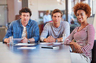 Buy stock photo Shot of a group of colleagues collaborating with each other on a project in an office