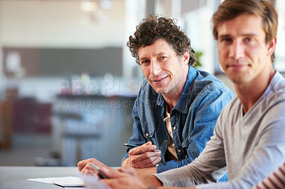 Buy stock photo Shot of a two coworkers collaborating with each other on a project in an office