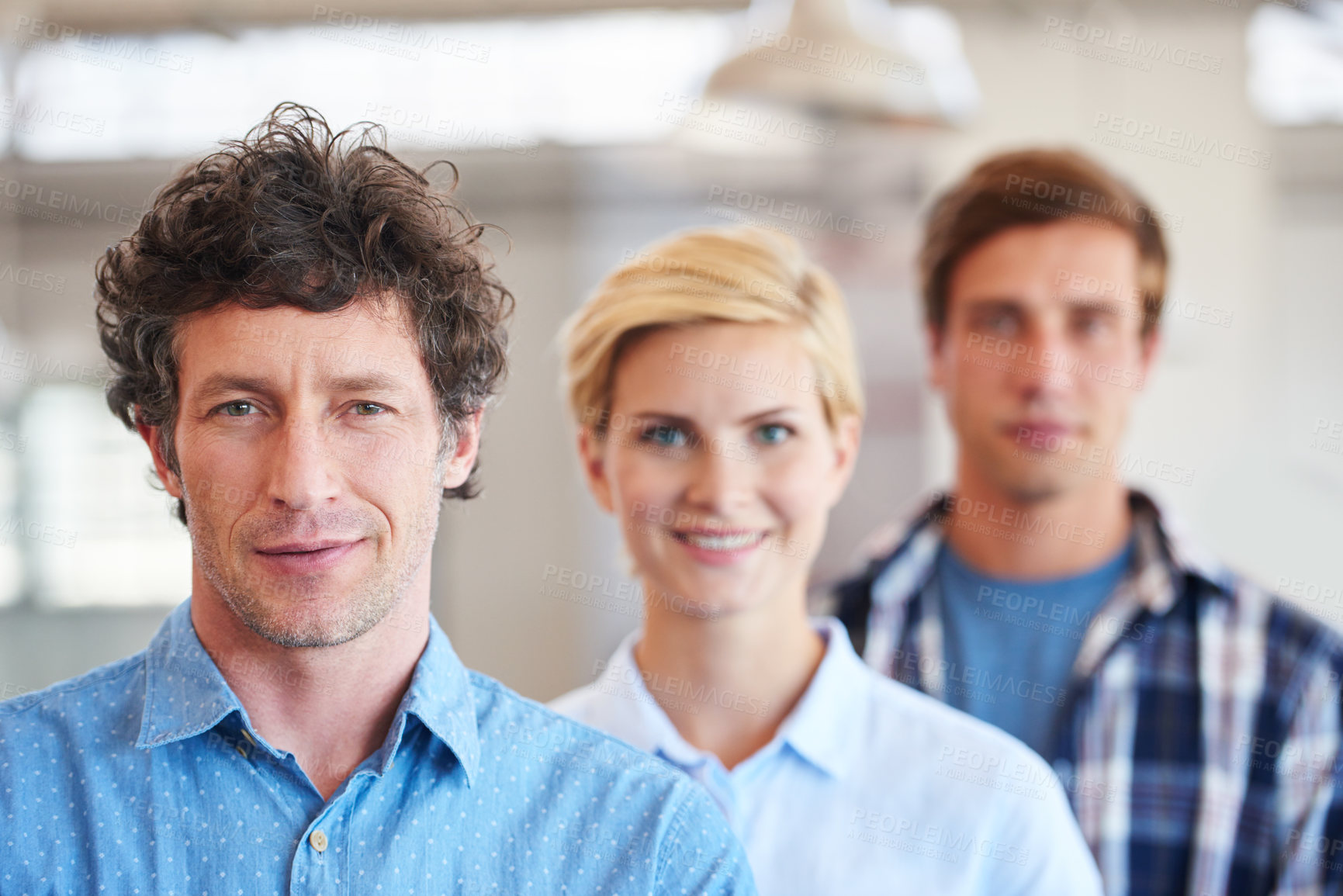 Buy stock photo Cropped portrait of three businesspeople standing in the office