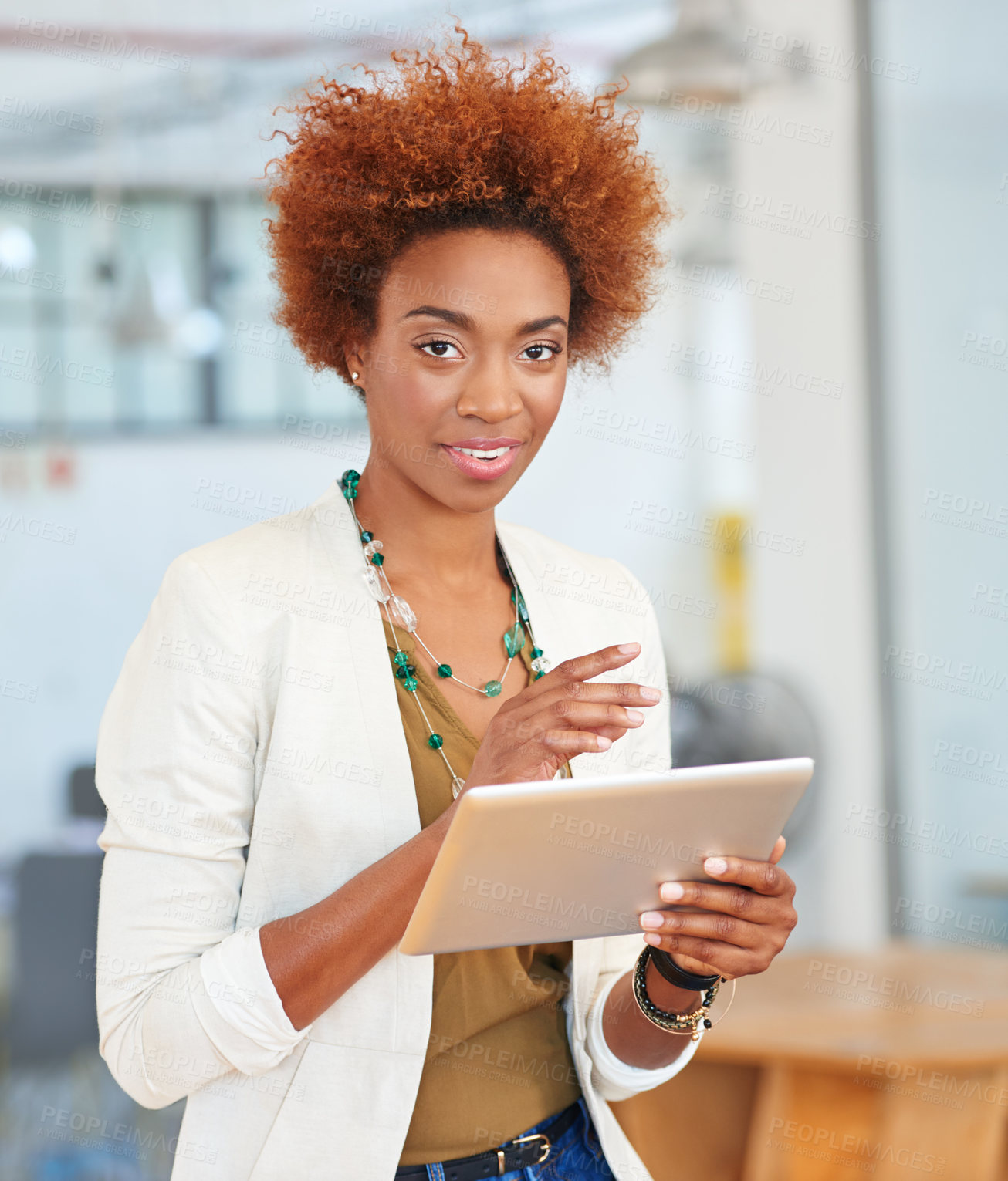 Buy stock photo Shot of a young businesswoman using a digital tablet in an office