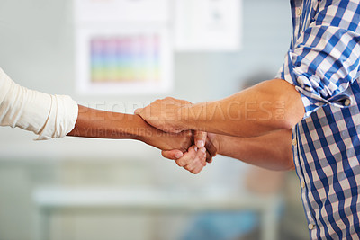 Buy stock photo Cropped shot of colleagues shaking hands