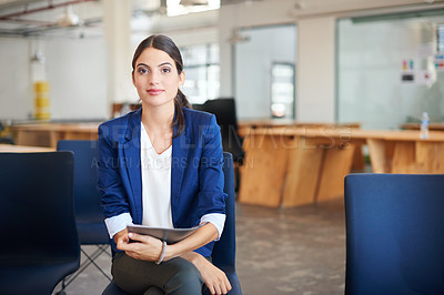 Buy stock photo A young businesswoman sitting in an office holding paperwork