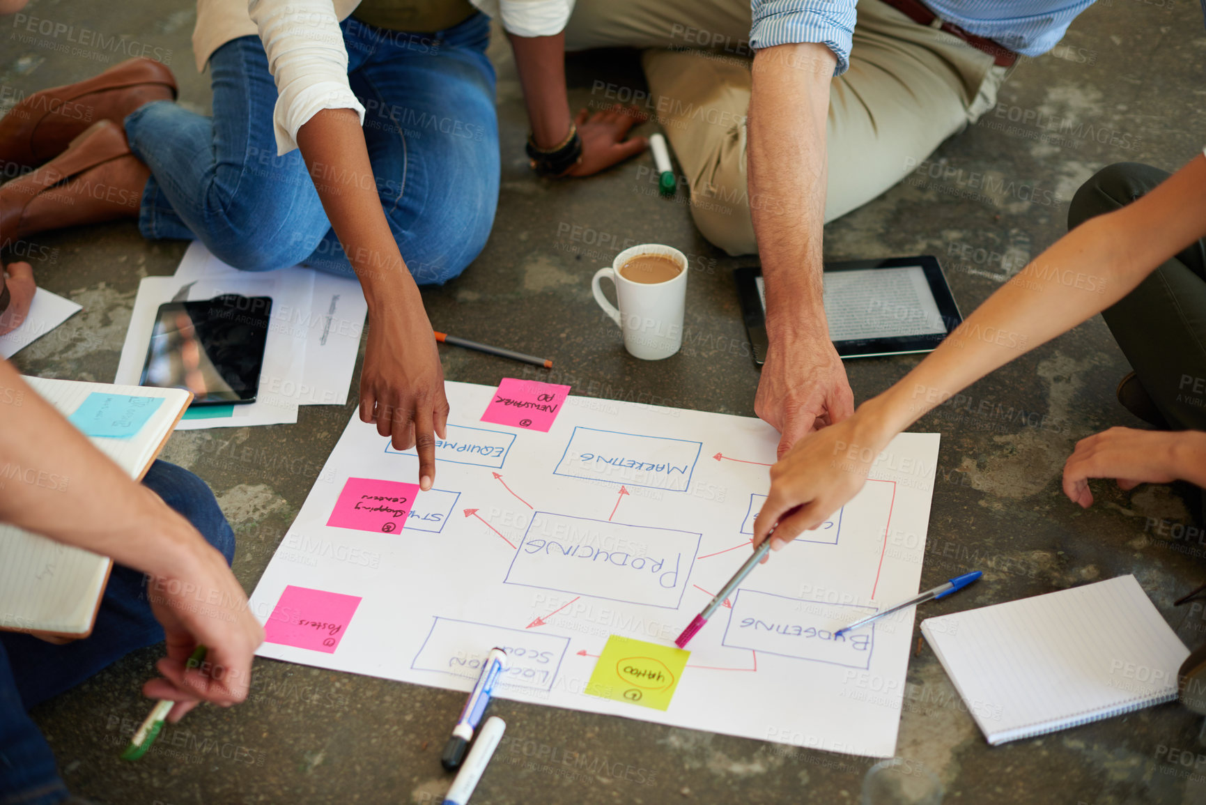 Buy stock photo Shot of a group of businesspeople brainstorming around a placard