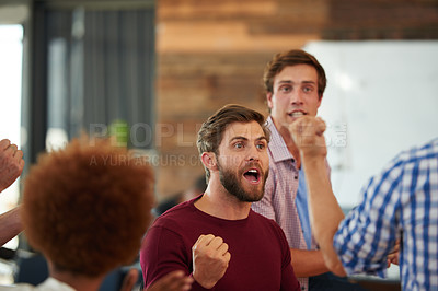 Buy stock photo Shot of a group of designers looking excited during an informal meeting