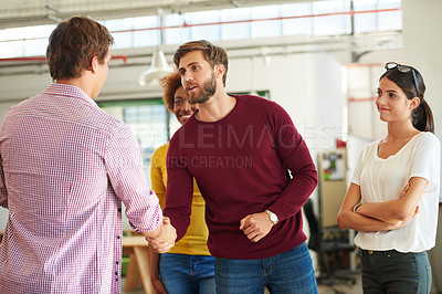 Buy stock photo Shot of a businesspeople shaking hands in an office