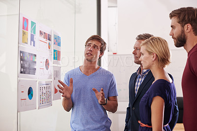 Buy stock photo Shot of a man presenting data to his colleagues