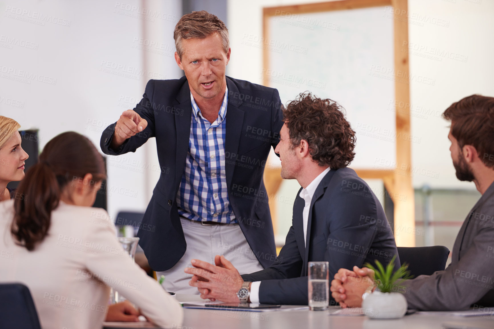 Buy stock photo Cropped shot of a businessman addressing his colleagues during a meeting