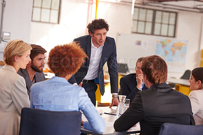 Buy stock photo Cropped shot of a businessman addressing his colleagues during a meeting