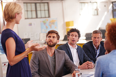 Buy stock photo Cropped shot of a businesswoman addressing her colleagues during a meeting