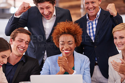Buy stock photo Cropped shot of a group of businesspeople gathered around a single laptop