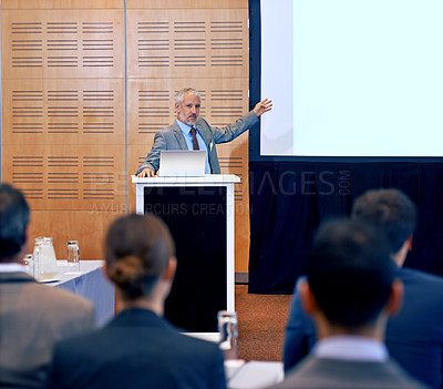 Buy stock photo Senior, businessman and speaker with presentation on projector for meeting, seminar or conference at office. Man, CEO or spokesperson talking on podium to group or corporate audience at workshop