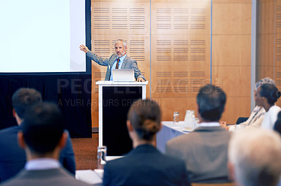 Buy stock photo Senior, businessman and spokesperson with presentation on projector for meeting, seminar or conference at office. Man, CEO or speaker talking on podium to group or corporate audience at workshop
