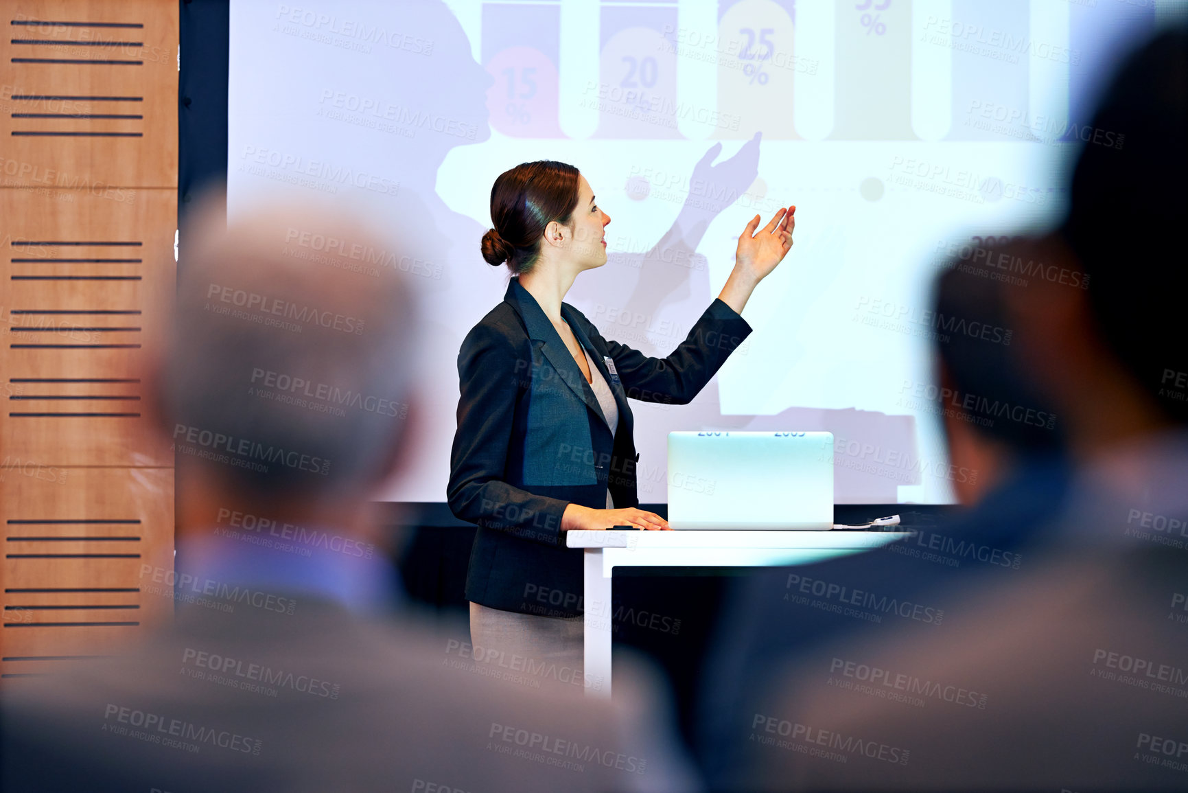 Buy stock photo A beautiful young businesswoman giving a presentation at a press conference