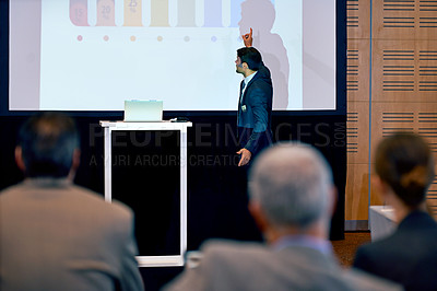Buy stock photo Businessman, presentation and podium with projector at conference in team meeting, staff training or seminar. Man, employee or speaker talking to group or audience with screen at corporate workshop