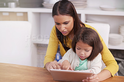 Buy stock photo Typing, home and mother with girl, tablet and bonding together with social media or connection. Online reading, family or mama with daughter or relax with tech or internet with digital app and movie