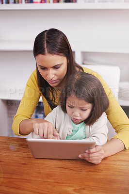 Buy stock photo Internet, home and mother with girl, tablet and digital app with connection and smile with website. Bonding together, family or mama with daughter or relax with tech, game or typing with social media