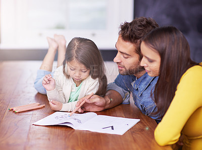 Buy stock photo Shot of a young family doing art work together