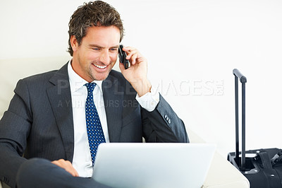 Buy stock photo Mature business man working on laptop and talking on mobile phone