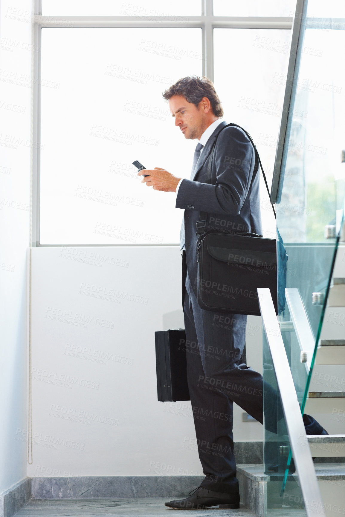 Buy stock photo Business man, phone and stairs with bag for reading news, information or serious email at office. Corporate lawyer, attorney or legal advisor typing on mobile FAQ, website and walking with briefcase 