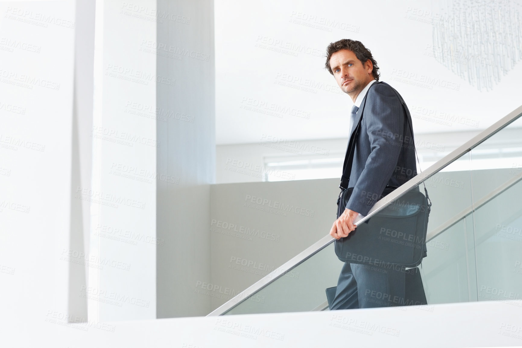 Buy stock photo Businessman, down and stairs or leaving office for walk, travel and going home from work in city. Male accountant, laptop bag or thinking on steps while departing with corporate fashion or briefcase