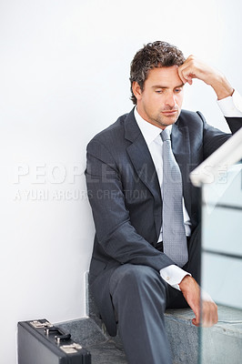 Buy stock photo Mature business man sitting on the stairs with hand on head