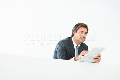 Buy stock photo Businessman, thinking and newspaper in studio on wall in white background for updates on stock market. Corporate, smiling and ideas for growth with reading for information or economy opportunities