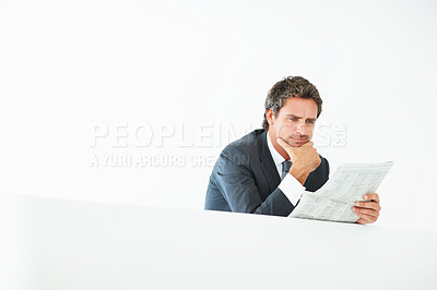 Buy stock photo Middle aged business man leaning on wall and reading newspaper