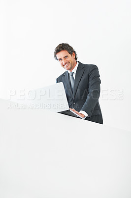 Buy stock photo Low angle view of business man standing with laptop on wall