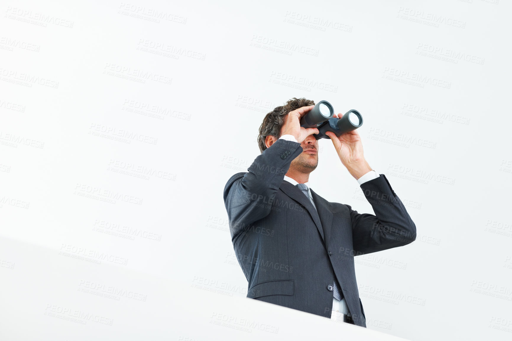 Buy stock photo Low angle view of handsome business man looking through binoculars