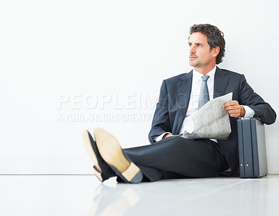 Buy stock photo Mature, businessman and newspaper for waiting in hotel or airport lobby with briefcase for travel. Male person or executive and luggage on floor reading paper or article for information for commute