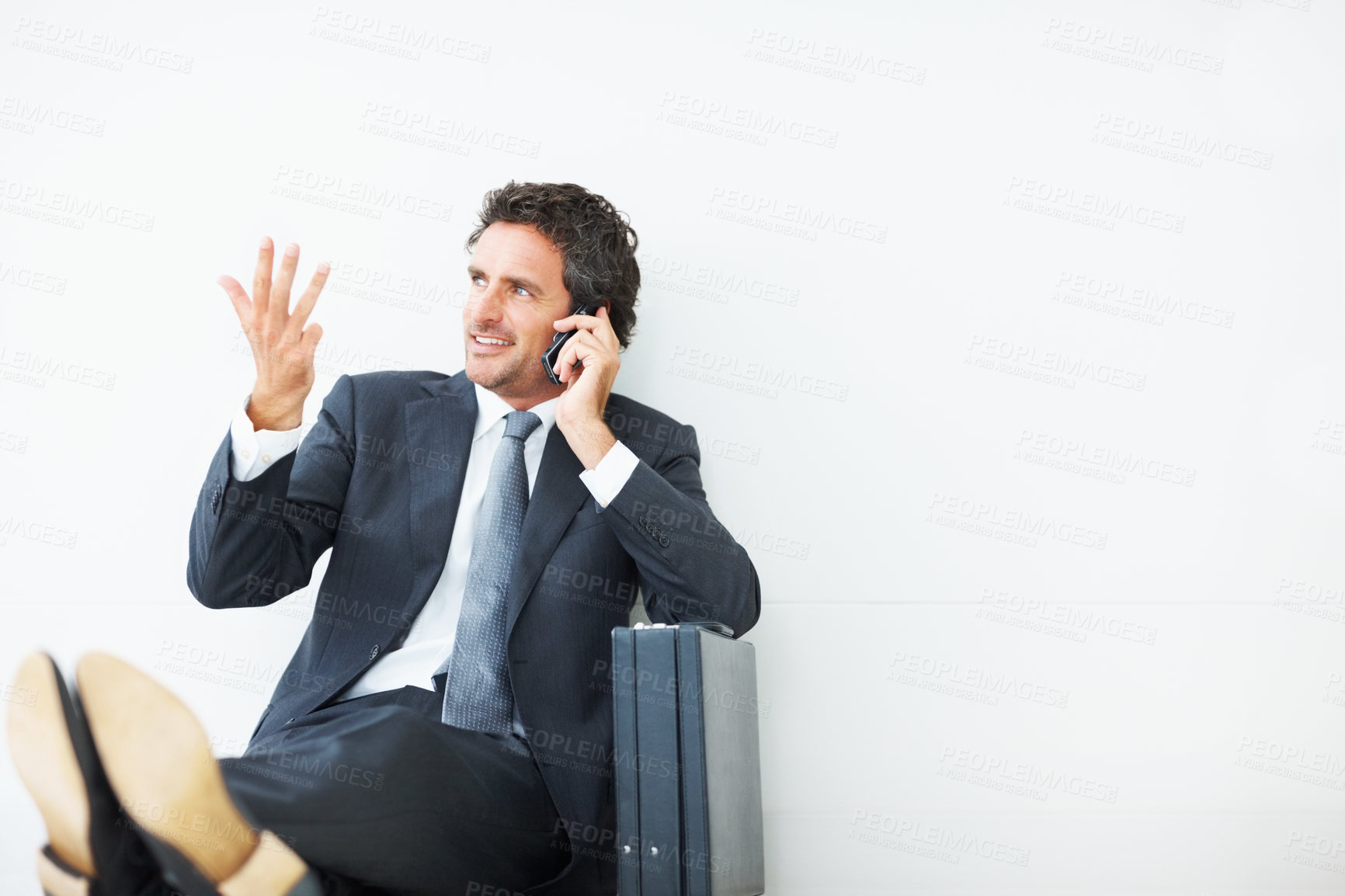 Buy stock photo Phone call, businessman and on floor with smile for relax, pride and isolated by white background for mockup. Professional, male consultant and thinking in studio for networking and communication